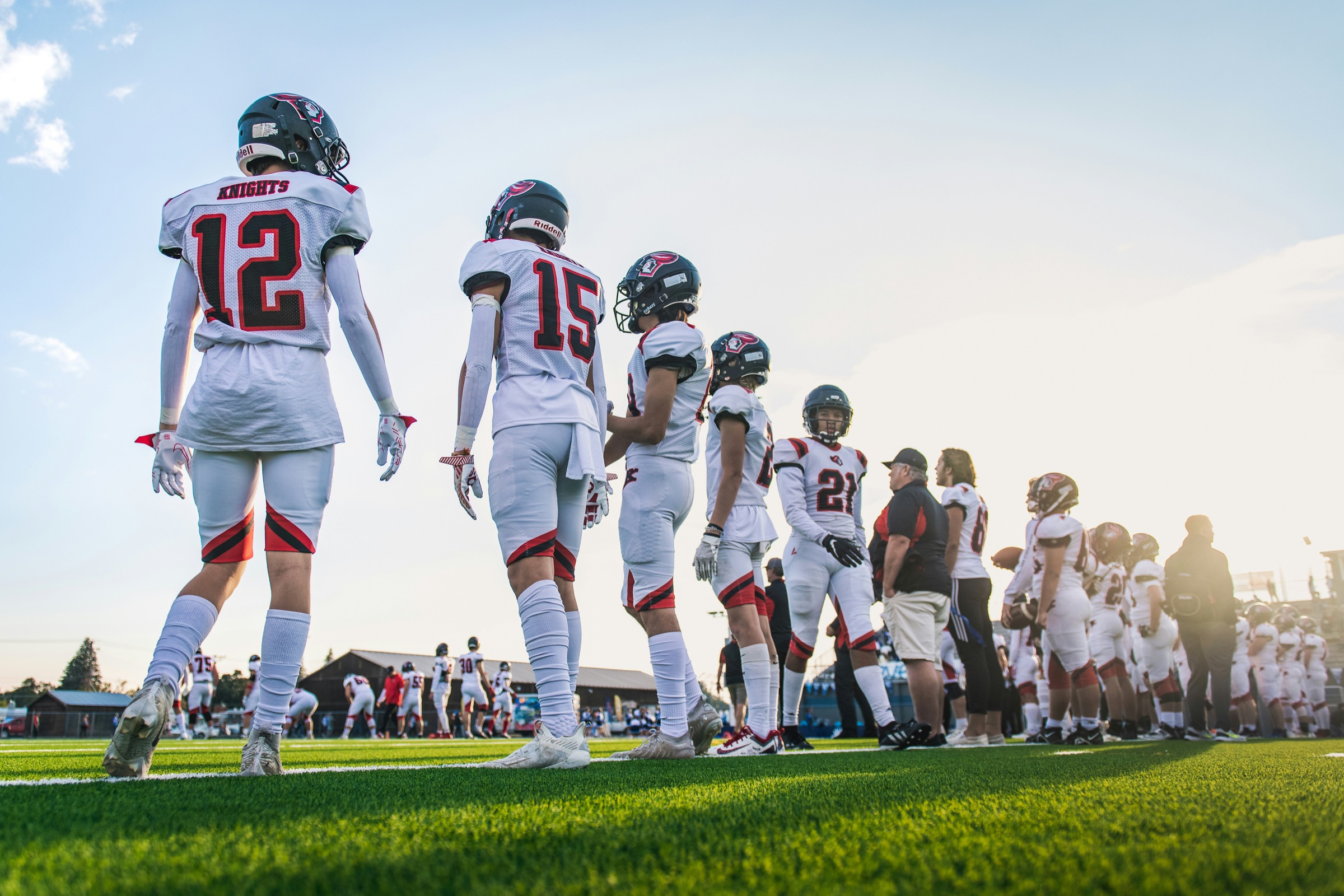 High school football players walking onto the field before a game